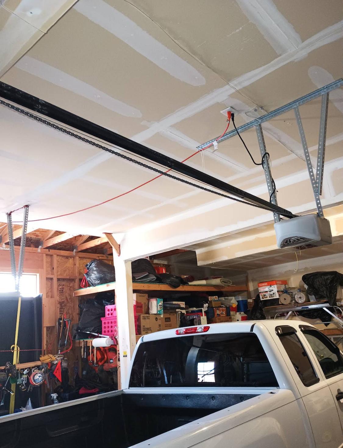 Garage door opener rail and track installed along the ceiling